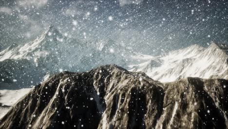 Heavy-snowing,-focused-on-the-snowflakes,-mountains-in-the-background